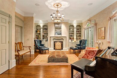 Formal Living with fireplace and built-in bookshelves.
