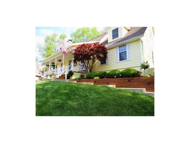 The Front Entryway Features Mature Landscaping & a Large Porch That Is Perfect for All Types of Furniture.
