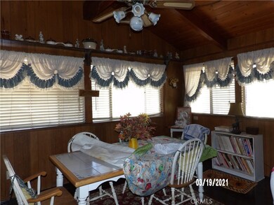 DINING ROOM ADJACENT TO KITCHEN WITH LOTS OF WINDOWS.