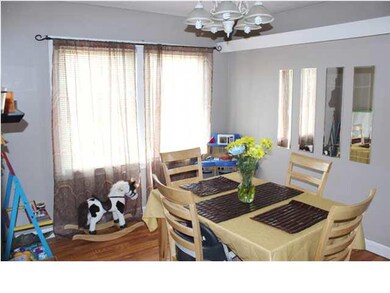 Large formal dining room with hardwood floor.