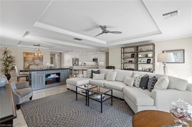 Tiled living room featuring sink, crown molding, c