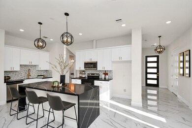 Marble flooring and upgraded light fixtures. The home has an upgraded modern front door.