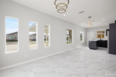Unfurnished living room featuring a chandelier, recessed lighting, and light marble finish flooring
