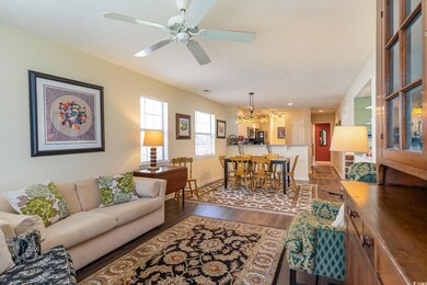 Living room featuring baseboards, dark wood-style 