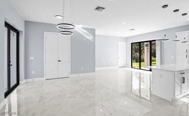 Spare room featuring baseboards and light marble f