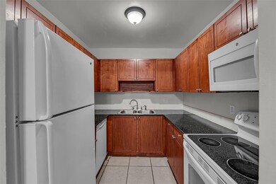 Kitchen offers cherry wood cabinets, granite count