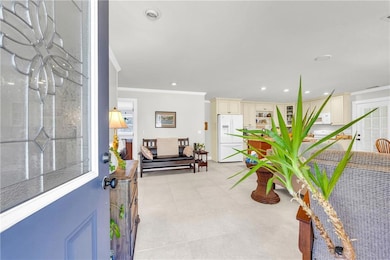 Entryway featuring crown molding, visible vents, a