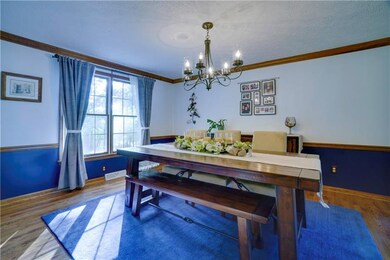 Dining Room with hardwood floors and crown mouldin