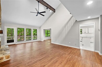 Unfurnished living room featuring wood finished floors, ceiling fan, high vaulted ceiling, beam ceiling, and recessed lighting