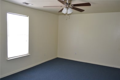 Carpeted spare room featuring healthy amount of na