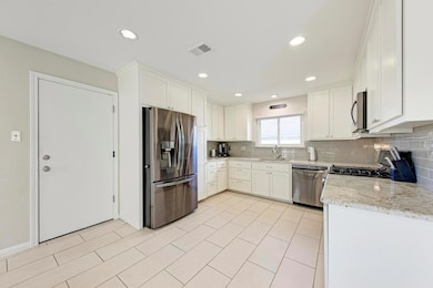 Kitchen with stainless steel appliances, backspla