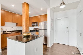 Kitchen featuring stainless steel appliances, a si