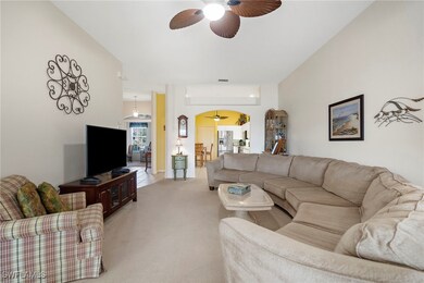 Living room featuring light carpet and ceiling fan