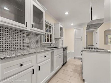 Kitchen featuring dishwasher, decorative backsplas