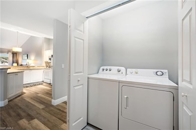 Washroom with separate washer and dryer and wood finished floors