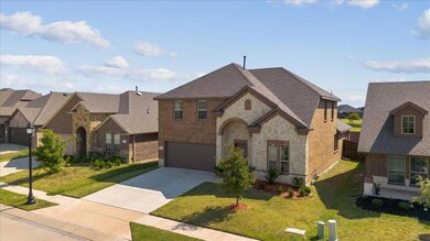 View of front of house with a garage and a front yard