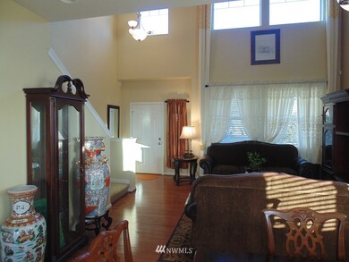Formal Living room with lots of natural Light. With Lovely Window Treatments.