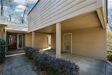 Doorway to property featuring a shingled roof