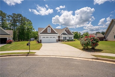 Craftsman-style home with driveway, a garage, ston