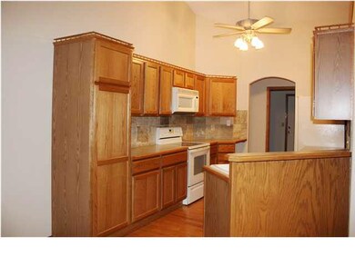 Kitchen with lovely hardwood flooring is open to e