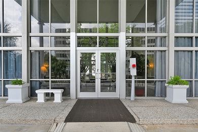 Grand lobby entry featuring glass walls, sleek finishes, and secured access for residents and guests.