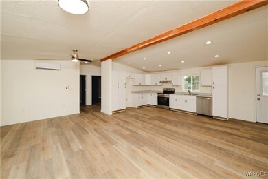Kitchen with a sink, light countertops, white cabi