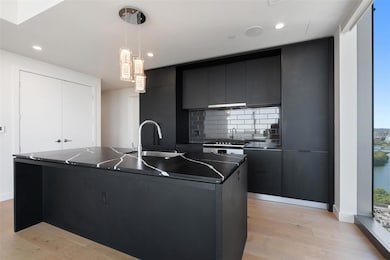 Kitchen with a sink, dark countertops, dark cabin
