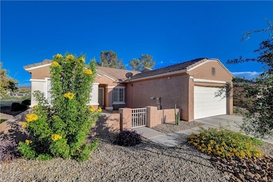 Ranch-style home featuring stucco siding, concrete driveway, an attached garage, and a tile roof