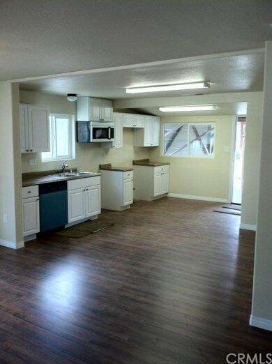 The open floor plan continues with the kitchen, co