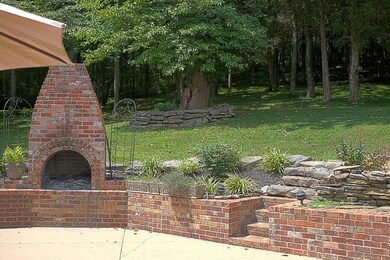 Outdoor Brick fireplace and Koi Pond