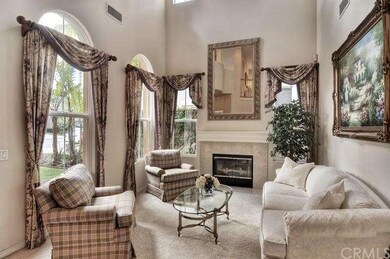 Formal living room with soaring ceilings and firep