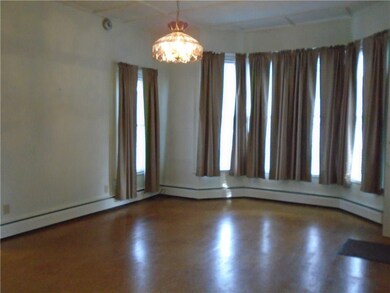 BIG living room with a wall of windows on one end.