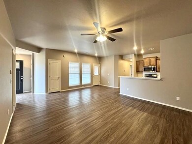 Unfurnished living room with ceiling fan, a textur