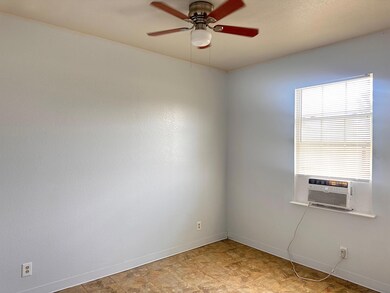 Spare room with ceiling fan, cooling unit, and ba