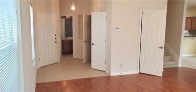 Hallway with light wood finished floors, baseboar
