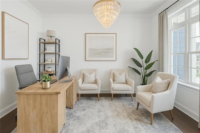 Sitting room featuring baseboards, a notable chand