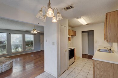 Kitchen featuring white range with electric stovet