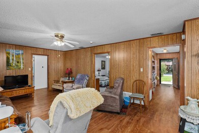 Living room with dark wood-type flooring, ceiling 