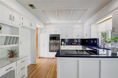 Hardwood floors and stainless steel appliances in 