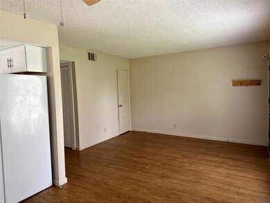 Spare room featuring dark wood-type flooring, a t