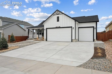 Modern inspired farmhouse with an attached garage, board and batten siding, a porch, driveway, and a shingled roof