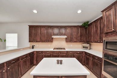 Large kitchen island with Corian countertops, tall