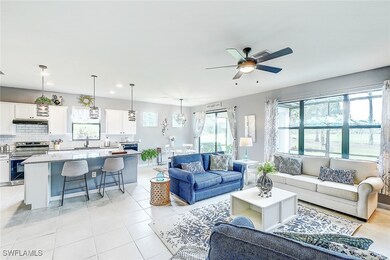 Tiled living room featuring ceiling fan, sink, and