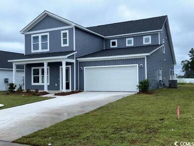 View of front facade with a garage, a front yard, 