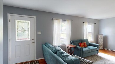 Entrance to home and view of living room