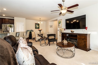 Carpeted living room with ceiling fan with notable