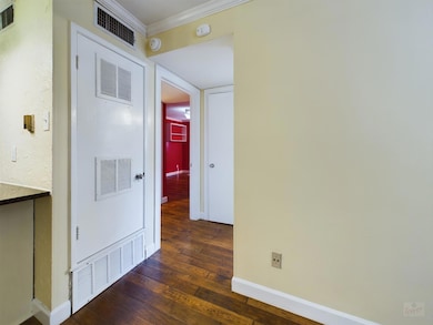 Corridor with baseboards, visible vents, ornament