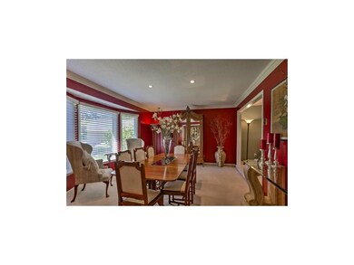 Formal dining room as bay windows with plenty of r