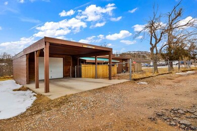 covered carport leads to garage