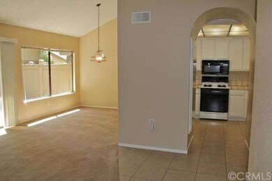 Large dining room, and an arched entry to a light 